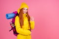Happy woman ready to hiking in unknown place she is carries big backpack on shoulders in pink studio background