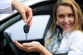 Happy woman receiving car key