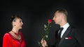 Happy woman in red dress and man with rose flower Royalty Free Stock Photo