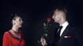 Happy woman in red dress and man with rose flower Royalty Free Stock Photo