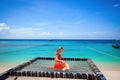 Happy woman in red dress relaxing hammock tropical beach Royalty Free Stock Photo