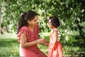 A happy woman in red dress with two years old girl in park Royalty Free Stock Photo