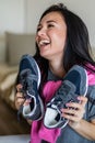 Happy woman rejoice holding new sneakers having fun and positive emotion. Sale discount buying