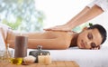 Happy woman, relax and back massage at spa for skincare, beauty or zen at hotel or resort. Calm female person or model Royalty Free Stock Photo