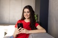Happy woman relaxing on comfortable sofa, enjoying web surfing information in internet or using mobile software application,