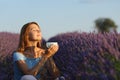 Woman drinking coffee in lavender field at sunset Royalty Free Stock Photo