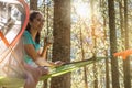 Happy woman relaxing in hanging tent camping in forest woods during sunny day.Group of friends people summer adventure Royalty Free Stock Photo