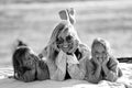 Happy woman relaxing with her two daughters outdoor on the beach, lying, talking and smiling. Mother`s day. Children`s day Royalty Free Stock Photo