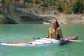 Woman relaxing in a kayak breathing fresh air in a lake