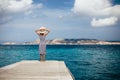 Happy woman relaxing on pier in Sardinia island, Italy Royalty Free Stock Photo