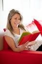 Happy woman relaxing reading a book Royalty Free Stock Photo