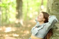 Happy woman relaxing sitting in a forest Royalty Free Stock Photo