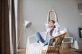 Happy woman resting comfortably on chair at home Royalty Free Stock Photo