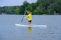 Happy woman resting on the SUP board and enjoying life in the early morning on the big river. Stand on the paddle boarding house Royalty Free Stock Photo