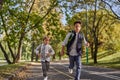 Happy woman riding on an e-scooter with her son. Young and beautiful caucasian woman rides electric scooter with boy in Royalty Free Stock Photo