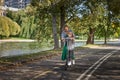 Happy woman riding on an e-scooter with her son. Young and beautiful caucasian woman rides electric scooter with boy in Royalty Free Stock Photo