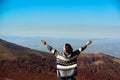 Happy woman rising hands up on top of autumn mountain. Travel, freedom and lifestyle Royalty Free Stock Photo