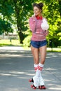 Happy woman on the roller-skate in the park