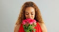 Happy woman, roses and valentines day with flowers for love, care or romance on a gray studio background. Portrait of
