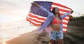 Happy woman running on beach while celebrateing independence day and enjoying freedom in USA Royalty Free Stock Photo