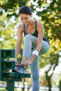 Happy woman, running or tying shoelaces in park, music or streaming audio for exercise in nature. Lady, smile or Royalty Free Stock Photo