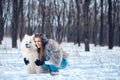 Happy woman with Samoyed dog in winter forest Royalty Free Stock Photo