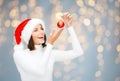 Happy woman in santa hat with christmas ball Royalty Free Stock Photo