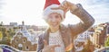 Happy woman in Santa hat at Guell Park with hands framing