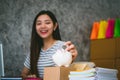 Happy woman saving money in a piggybank Royalty Free Stock Photo