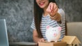 Happy woman saving money in a piggybank Royalty Free Stock Photo