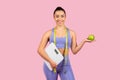 Happy woman with scale and apple, fitness concept Royalty Free Stock Photo