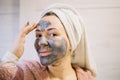 Happy woman scrubbing mask on her face Royalty Free Stock Photo