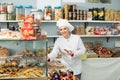 Happy woman seller offering sweets Royalty Free Stock Photo