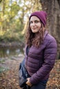 Happy woman with a serene smile standing in the forest