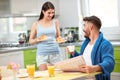 Woman serving rich breakfast to husband Royalty Free Stock Photo