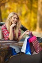 Happy woman with shopping bags in convertible car Royalty Free Stock Photo