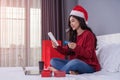 happy woman shopping online for Christmas gift with digital tablet and credit card on bed Royalty Free Stock Photo