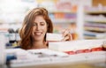 Happy woman, shopping and pharmacy on shelf for pills, medication or drugs for healthcare at store. Female person