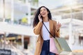 Happy woman, shopping and phone call in the mall in communication about lifestyle in the outdoors. Female shopper having Royalty Free Stock Photo