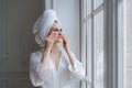 Happy woman after shower takes care clean skin and pores, holds cotton pad Royalty Free Stock Photo