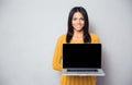 Happy woman showing blank laptop screen Royalty Free Stock Photo