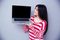 Happy woman showing blank laptop screen Royalty Free Stock Photo