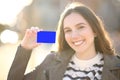 Happy woman showing credit card at camera Royalty Free Stock Photo