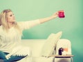 Happy woman showing cup of tea Royalty Free Stock Photo