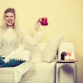 Happy woman showing cup of tea Royalty Free Stock Photo