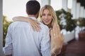 Happy woman showing engagement ring