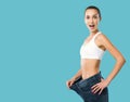 Happy woman showing her successful weight loss Royalty Free Stock Photo