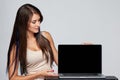 Woman showing blank black laptop computer screen Royalty Free Stock Photo