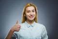 Happy woman showing thubs up. Closeup Portrait girl smiling isolated on grey Royalty Free Stock Photo