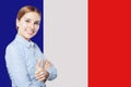 Happy woman showing thumb up on French flag background. Royalty Free Stock Photo